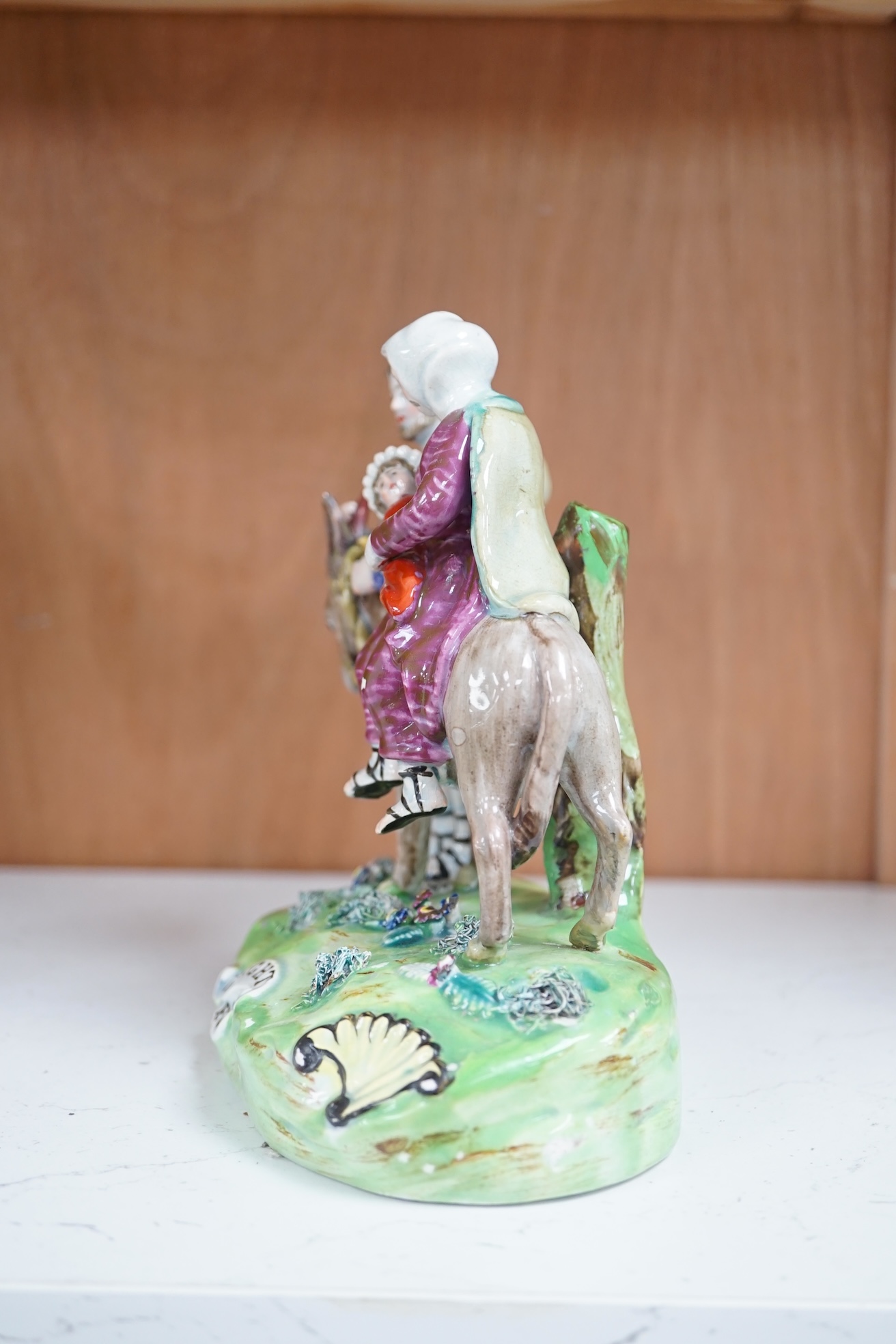 An early 19th century pearlware ‘flight to Egypt’ group, by Walton, 16.5 cm high. Condition - some restoration and bocage lacking